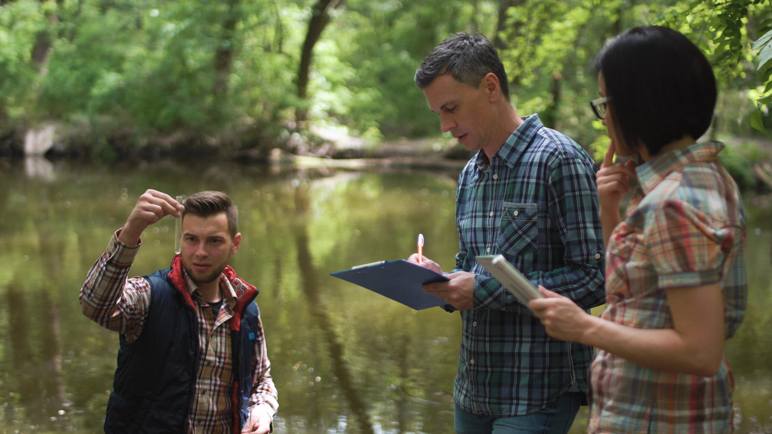 Three scientists exploring water in lake